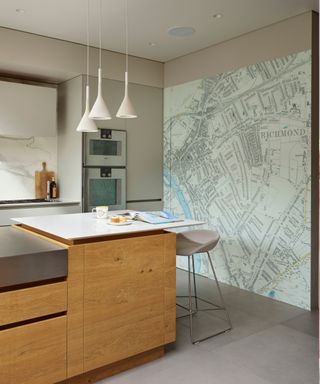 Countemporary kitchen with a wooden island and a London map mural